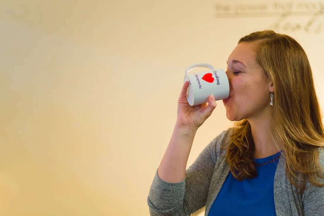 A woman sipping tea from a mug