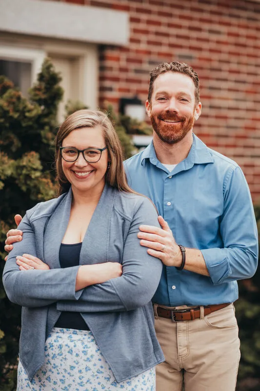 Dr. Amanda Halstead and Dr. Brendan Riordan standing together outside the office